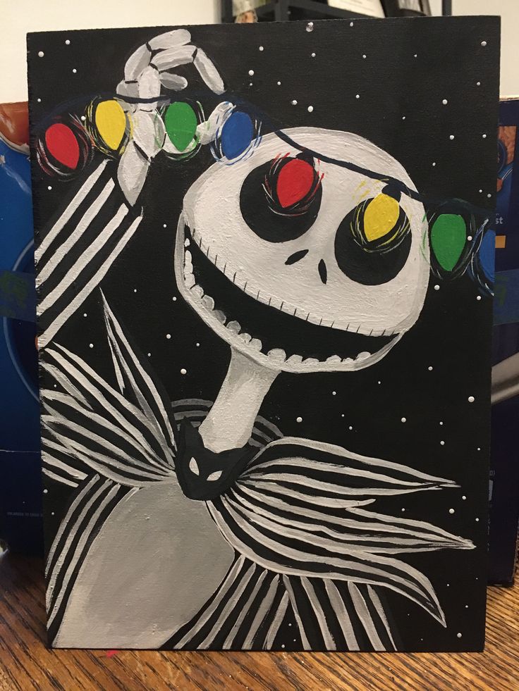 a painting of a skeleton with christmas lights on it's head is sitting on a table