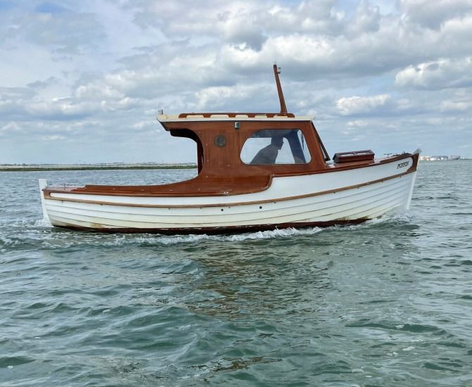 a white and brown boat in the water