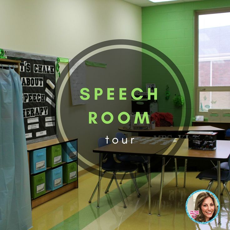 a classroom with green walls and black desks in front of a large round sign that says speech room tour