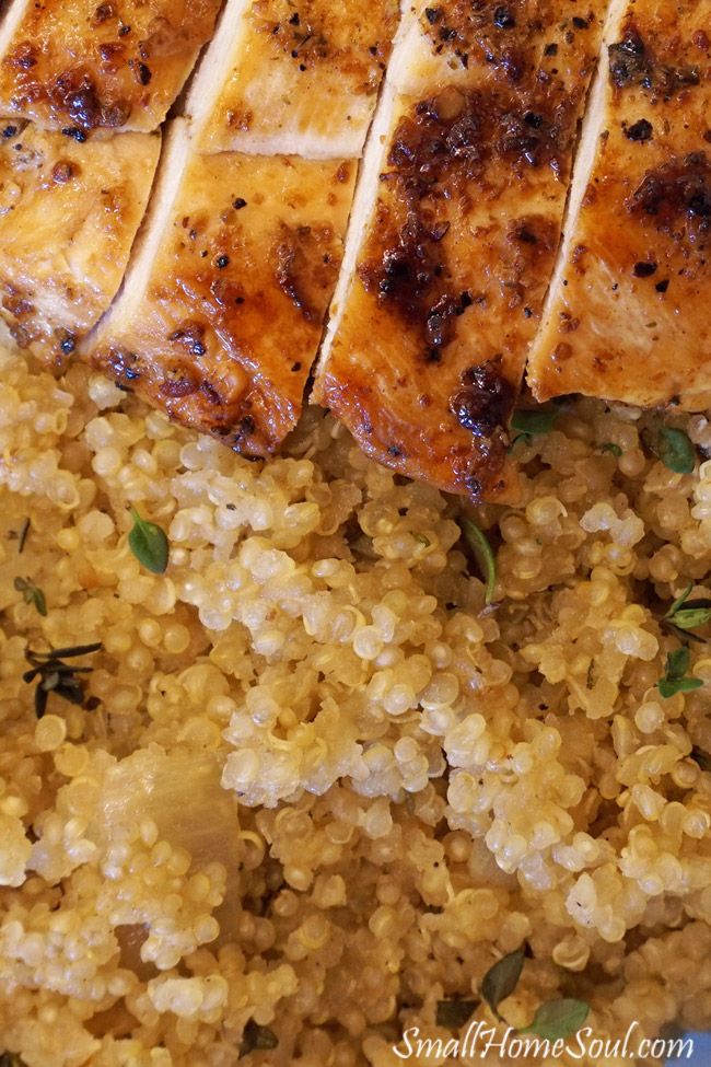 some chicken and rice on a plate with garnished with green leafy herbs