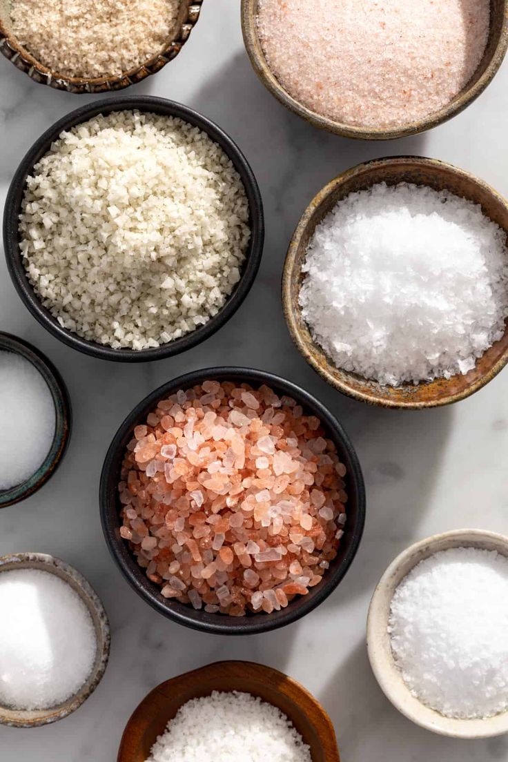 several bowls filled with different types of sugar