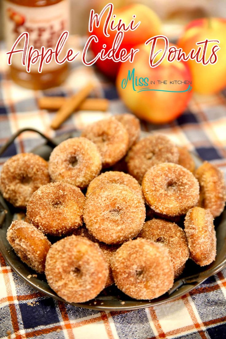 apple cider donuts on a plate with apples in the background