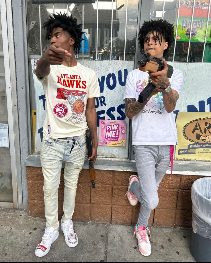 two young men standing in front of a store