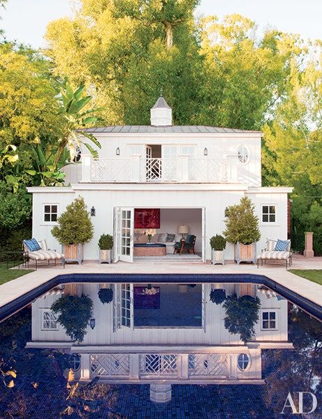 a house with a pool in front of it and an advertise for the home