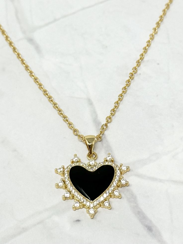 This Love Abounds Black Heart Pendant Necklace is the layering champion of accessories. The sleek, black pendant makes a bold statement while adding a touch of love to any outfit. Show off your playful side with this quirky and fun necklace. Perfect for those who don't take themselves too seriously! 1 Black Heart Pendant 48 cm long 18k Gold Plated Over Brass 18K Gold Center Stone Extendable Lobster Clasp Trendy Black Charm Necklaces For Gifts, Black Necklace With Adjustable Chain For Valentine's Day, Trendy Black Charm Necklace For Gifts, Trendy Black Jewelry For Gifts, Black Adjustable Chain Heart Pendant Jewelry, Trendy Black Necklace With Adjustable Chain, Black Heart Pendant Necklace With Adjustable Chain, Black Heart-shaped Jewelry With Adjustable Chain, Black Heart Charm Pendant Jewelry