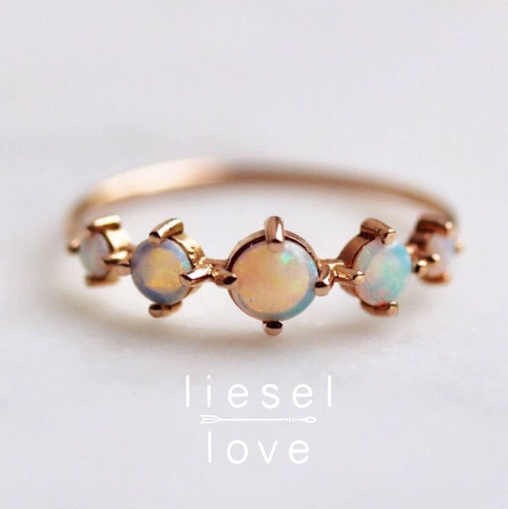 The incredible hints of blue, pink, green and purple in this ring make it so gorgeous, it feels like magic.  Our "Talisman" ring is set in 14K gold and features 5 Australian prong set opals. - Handcrafted out of solid 10K or 14K gold - Choose between rose, yellow and white gold - Round band measures 1mm - Opals measure 2mm, 3mm and 4mm (5 stones total) - Set with natural Australian Opals Processing times -  Current processing time is 1 - 3 weeks.  Each Item is handmade to order with love and car 14k Gold Celestial Opal Ring, Celestial 14k Gold Opal Ring, Spiritual Opal Rings, 14k Gold Opal Ring Gift, Spiritual 14k Gold Opal Ring Gift, Heirloom Opal Jewelry In Round Shape, Heirloom Opal Jewelry, Spiritual Opal Jewelry For Promise Ring, Spiritual Opal Ring Jewelry