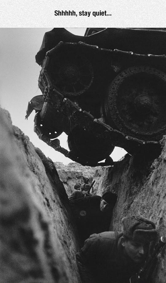 an old black and white photo of men digging in the dirt with large wheels on it