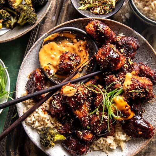 a plate full of food with chopsticks and sauce on it, next to other dishes