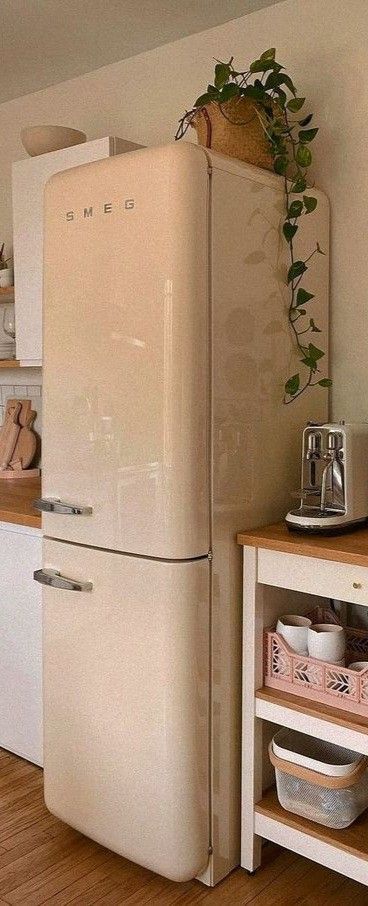 a white refrigerator freezer sitting inside of a kitchen next to a wooden counter top