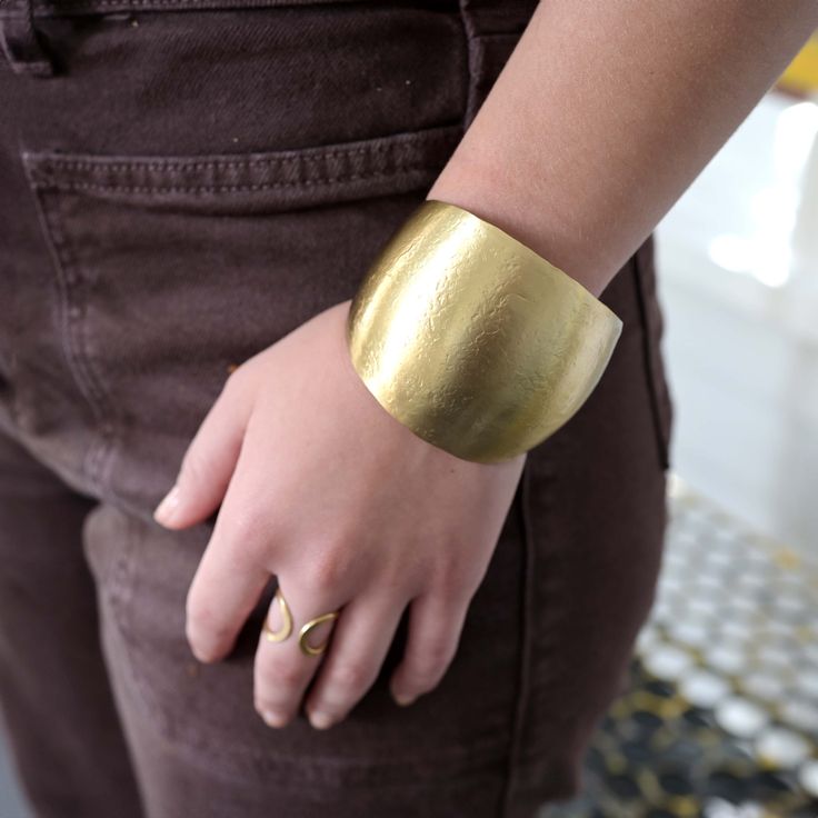 Be transported to Ancient Greece with this matte metallic cuff! With its sleek sculptural arch, it's a perfect showstopper. Complete the look with our Kantha jewelry or mix it with other metallic pieces. Handmade by women artisans in India. Modern Brass Bangle Cuff Bracelet, Modern Hammered Metal Cuff Bracelet, Modern Brass Cuff Bracelet, Modern Brass Cuff Bangle, Adjustable Contemporary Cuff Bracelet, Modern Hand Cast Adjustable Bracelets, Modern Adjustable Hand Cast Bracelets, Modern Brass Cuff Bracelets, Modern Metal Wide Band Bracelets