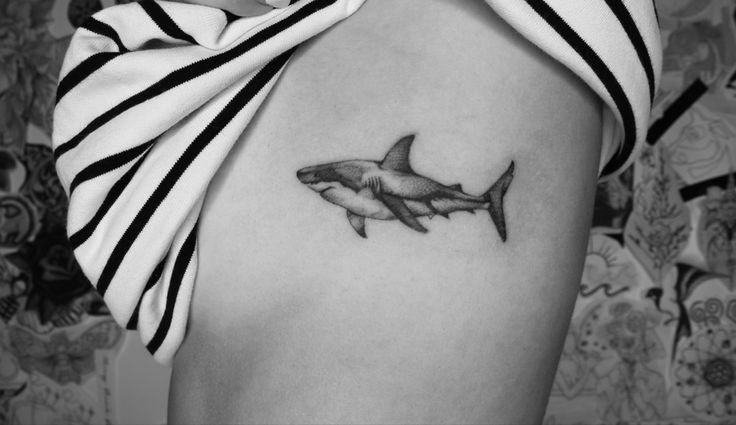 a black and white photo of a shark tattoo