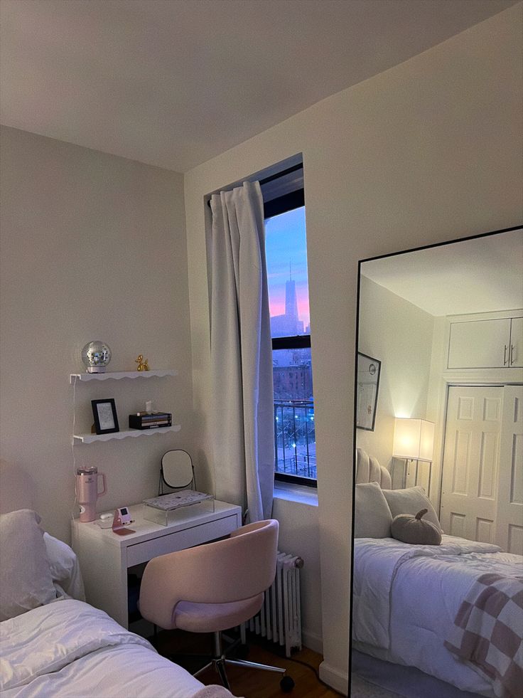 a bedroom with a bed, desk and mirror on the wall in front of it