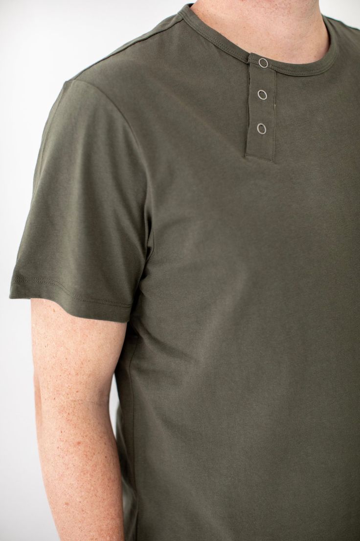 The Essential Everyday Henley Shirt Our core workwear Henley Tee is now available in a new color: Olive. This versatile tee features an apron neck tab and sleeve pocket, making it a practical choice for kitchen and service staff. Customize it with logos to impress, or let its understated silhouette make a statement on its own. Crafted from 100% premium cotton sourced from China, this tee offers substantial quality in the classic new Olive color. Pair it with the Olive Essentials Pants for a cohe Relaxed Fit Button T-shirt For Everyday, Everyday Cotton T-shirt With Buttons, Cotton T-shirt With Buttons For Everyday, Relaxed Fit Short Sleeve Polo Shirt With Buttons, Everyday Relaxed Fit T-shirt With Buttons, Collared Cotton T-shirt For Everyday, Cotton Collared T-shirt For Everyday, Everyday Crew Neck T-shirt With Buttons, Khaki Cotton Short Sleeve Polo Shirt