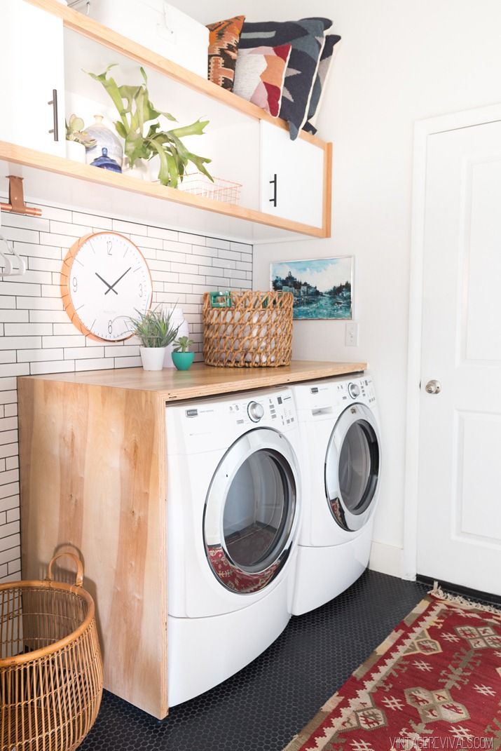 a washer and dryer sitting in a room next to each other on top of a rug