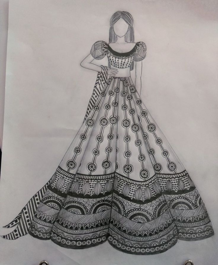 a drawing of a woman's dress on paper with scissors in front of it