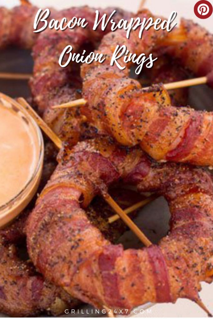 bacon wrapped onion rings on skewers with dipping sauce