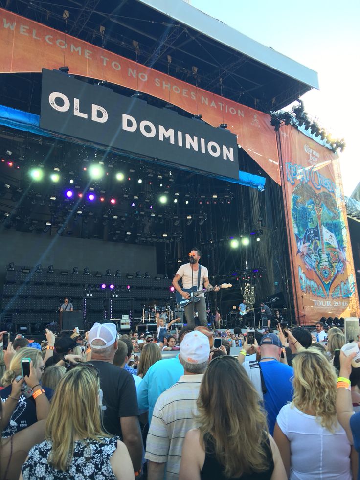 a man standing on top of a stage in front of a crowd