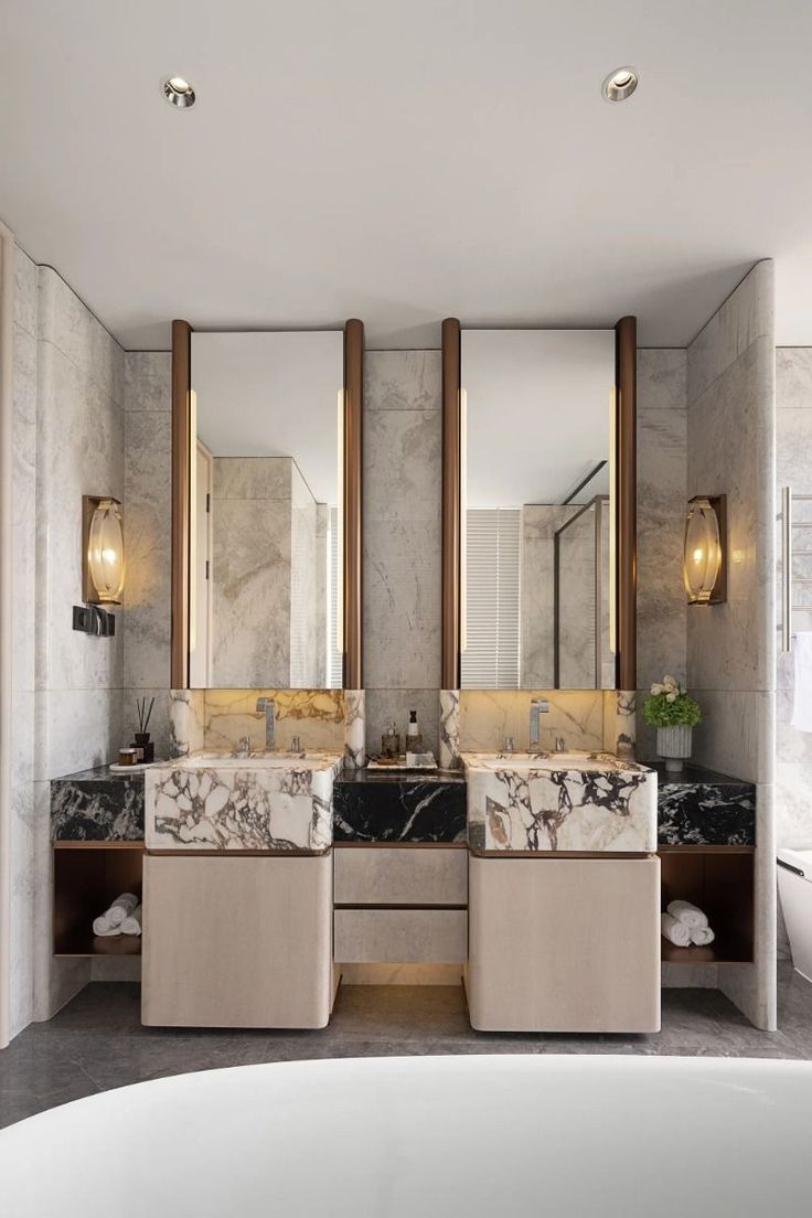 a bathroom with marble counter tops and two sinks