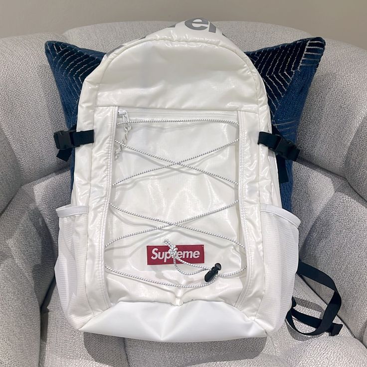 White Backpack From The Supreme Fw17 Season, It Has Little Stains But Nothing Major Designer Backpack With Zipper Pocket, White Zipper Closure Bag For Streetwear, White Rectangular Shoulder Bag For Streetwear, White Backpack With Zipper Closure For Streetwear, White Backpack For Streetwear, White Bags With Adjustable Strap For Streetwear, White Bag With Adjustable Strap For Streetwear, White Streetwear Bag With Adjustable Strap, White Large Capacity Backpack For Streetwear