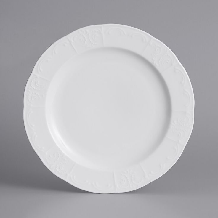 an empty white plate on a gray background