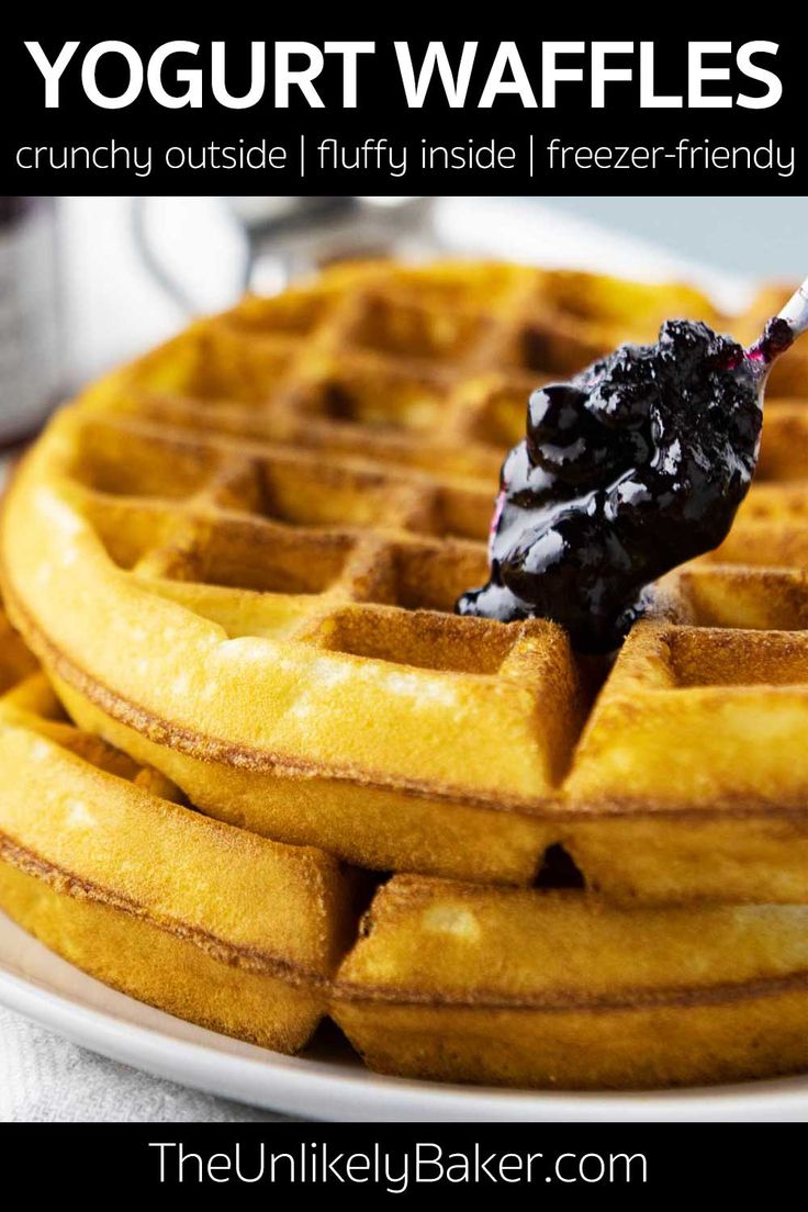 a stack of waffles on a plate with syrup being drizzled over them