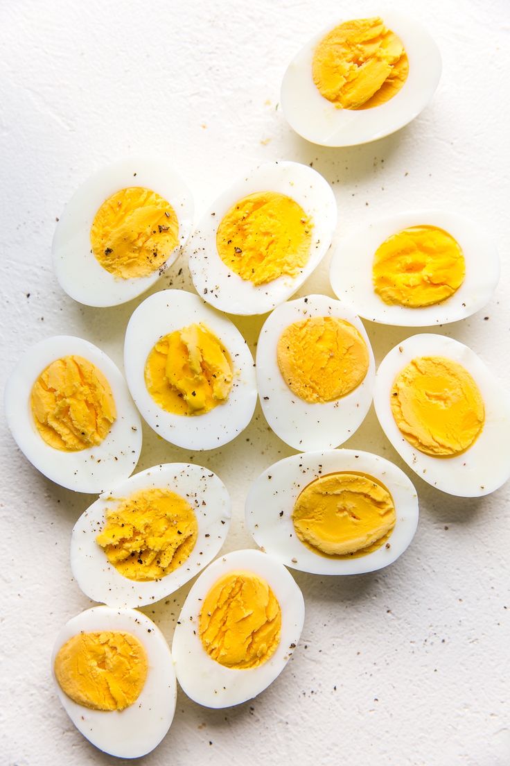 hard boiled eggs with yellow mustard spread on them, laid out in a circular pattern