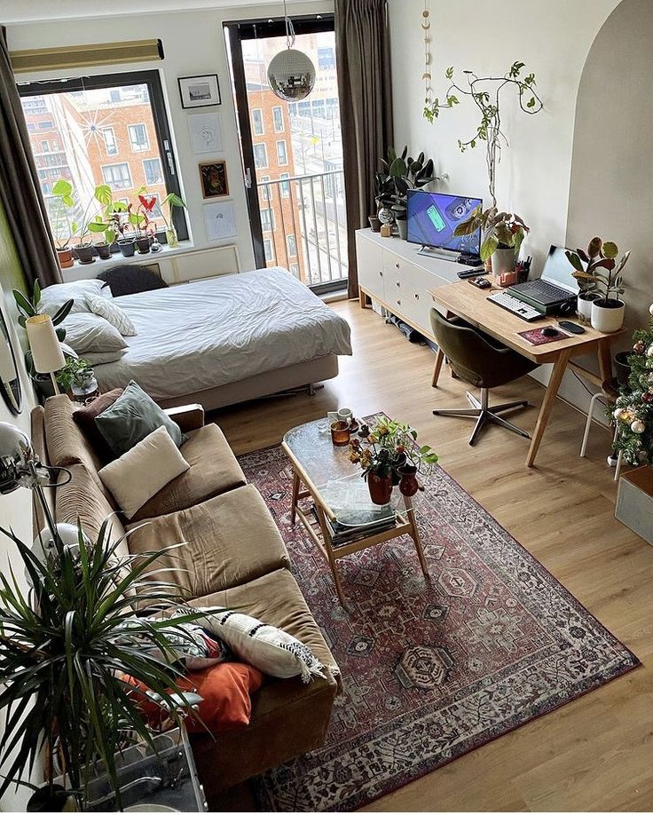 a living room filled with furniture and a flat screen tv sitting on top of a wooden floor