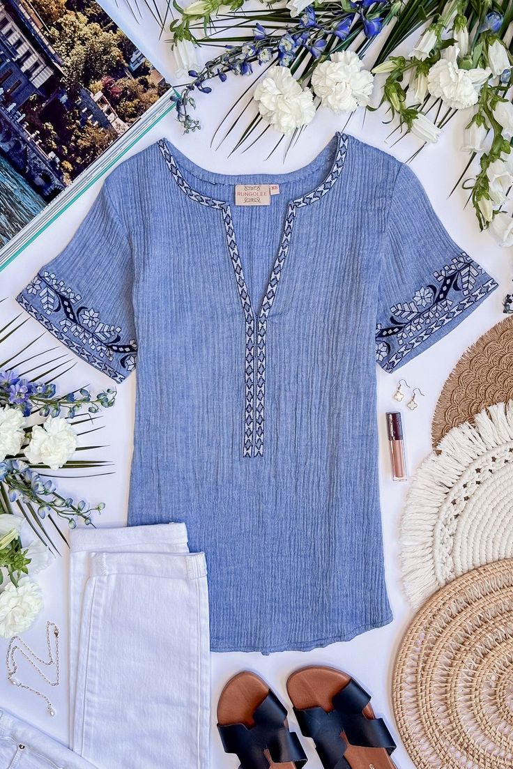 Inspired by the gorgeous mediterranean island of Sicily, this blouse is the epitome of vacation-chic. We love the soft cotton crinkle gauze of this easy breezy style, detailed with the prettiest embroidery at the v neck and sleeves. Pair with a straw bag and sandals. Spring Linen Tunic With Embroidery, Summer Embroidered V-neck Peasant Top, Chic Rayon Tunic For Summer, Embroidered V-neck Peasant Top For Beach, Breezy Short Sleeve Tops For Beach Season, Cotton V-neck Beachwear Tops, Summer V-neck Tunic With Chikankari Embroidery, Cotton V-neck Peasant Top For Vacation, Flowy Cotton Blouse With Floral Embroidery