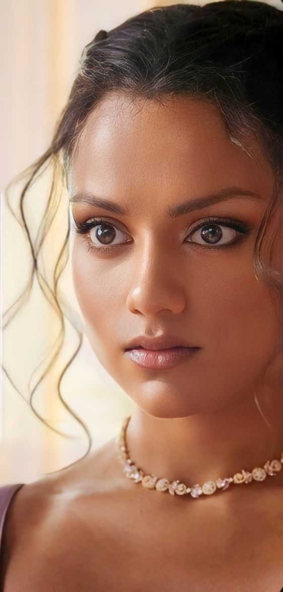 a beautiful young woman wearing a pearl necklace