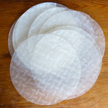 four white plates sitting on top of a wooden table