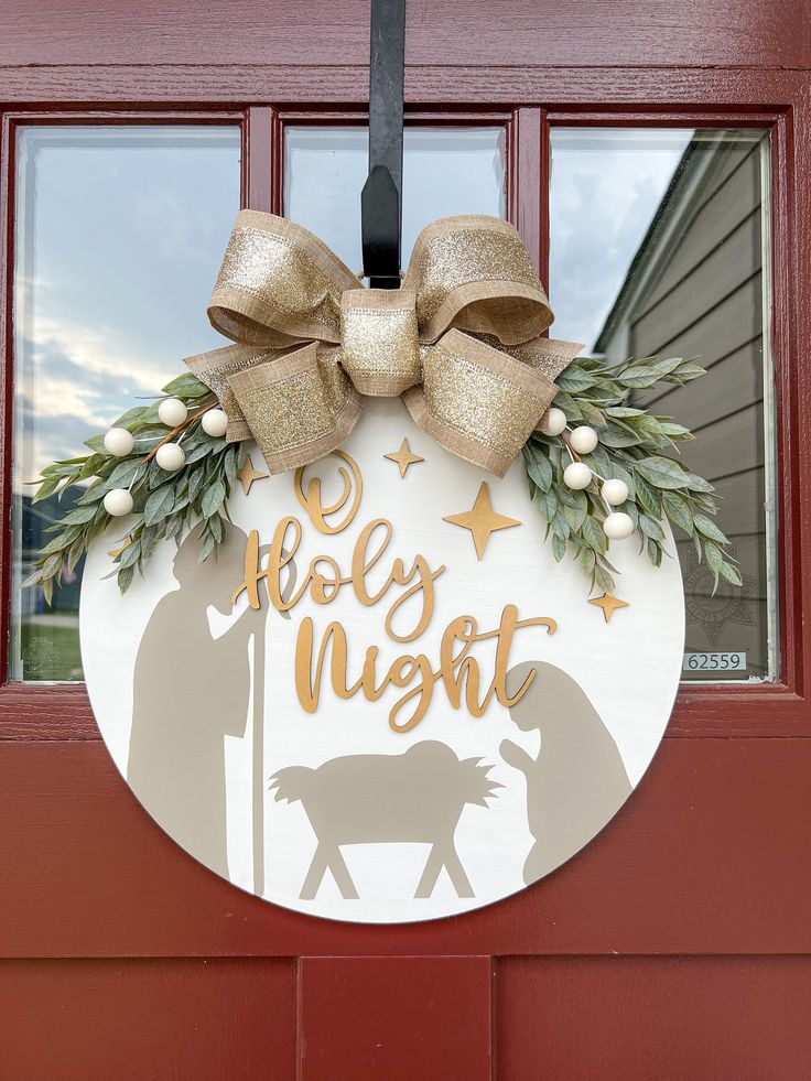 a door hanger that says, baby night with a horse and wreath on it