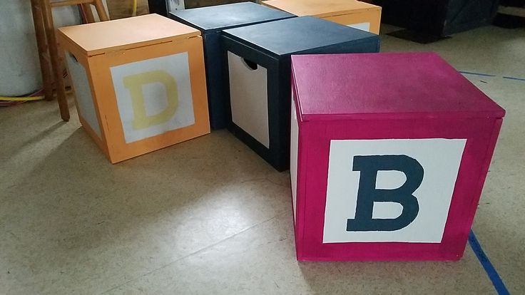 three blocks with the letter b painted on them in different colors and sizes, sitting next to each other