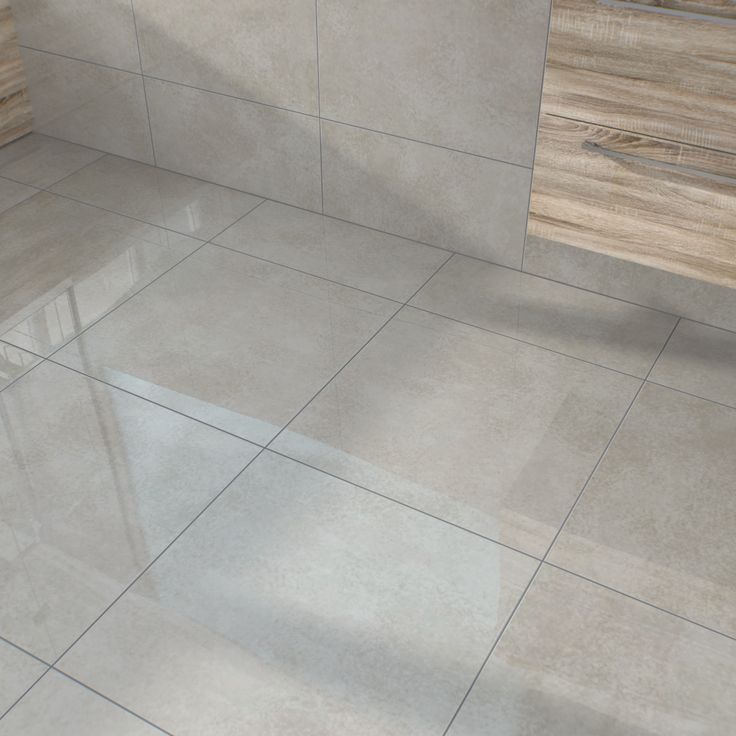 a bathroom with white tile and wooden cabinets