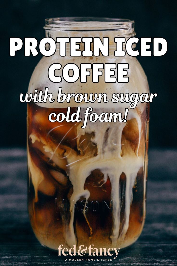 a jar filled with brown sugar and white icing on top of a wooden table