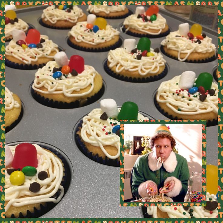 cupcakes decorated with white frosting and colorful candies are on a baking tray