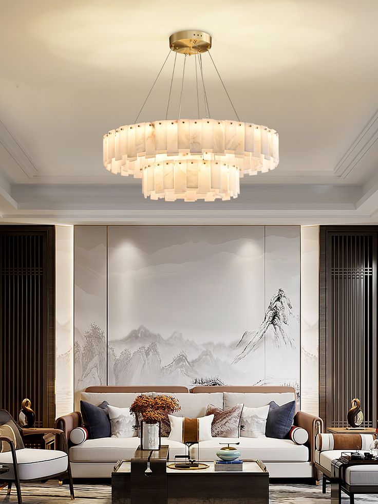 a living room filled with furniture and a chandelier hanging over the top of it