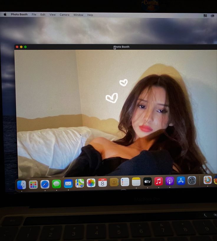 an image of a woman on the screen of a laptop