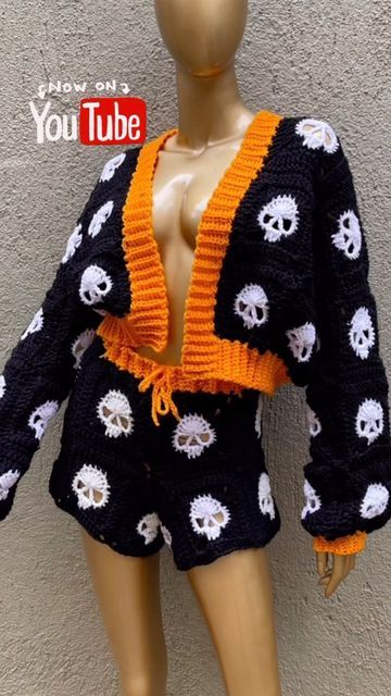 a mannequin wearing a black and white sweater with skulls on it