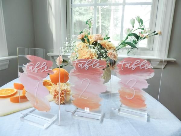 the table is set up with oranges and flowers