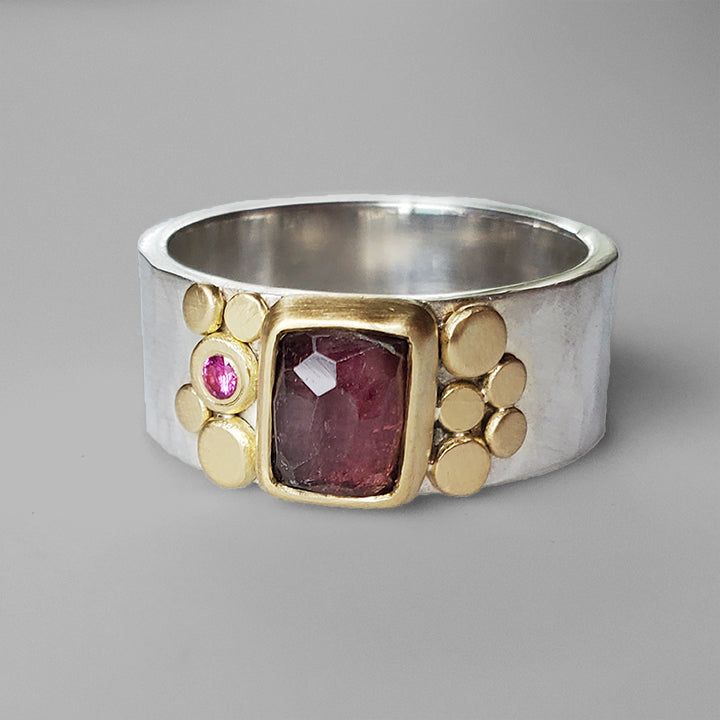 This little faceted raspberry pink tourmaline has a lovely glow that really captures its depth. A hammered faceted 8mm silver band displays this pretty pink tourmaline in an 18k yellow gold bezel with gold dot flourishes on either side and a small pink sapphire flush set accent. Size 8. Can be sized upon request. Arrives to you in a special gift box. Aura Ring, Silver Stone Ring, Gold Dot, Unusual Rings, Organic Rings, Raspberry Pink, Gold Dots, Deep Pink, Metal Work