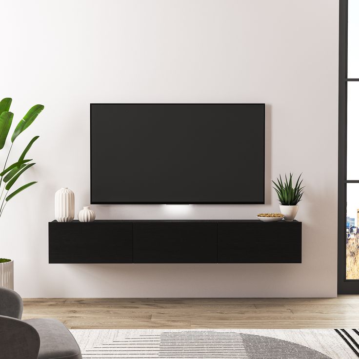 a large flat screen tv mounted to the side of a wall in a living room