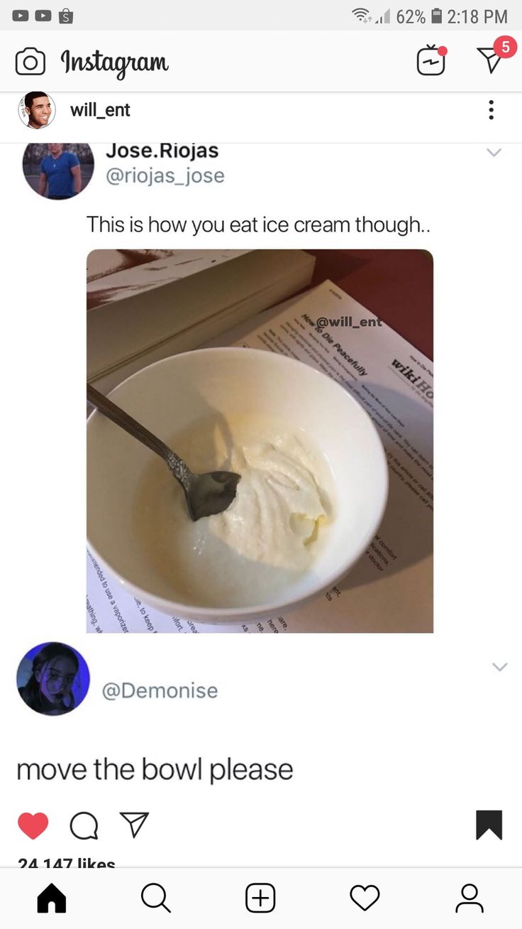 a bowl of cream with a spoon sticking out of it on top of a table