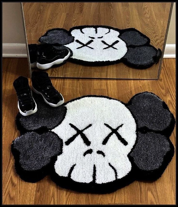 a pair of shoes sitting on top of a rug in front of a mirrored wall