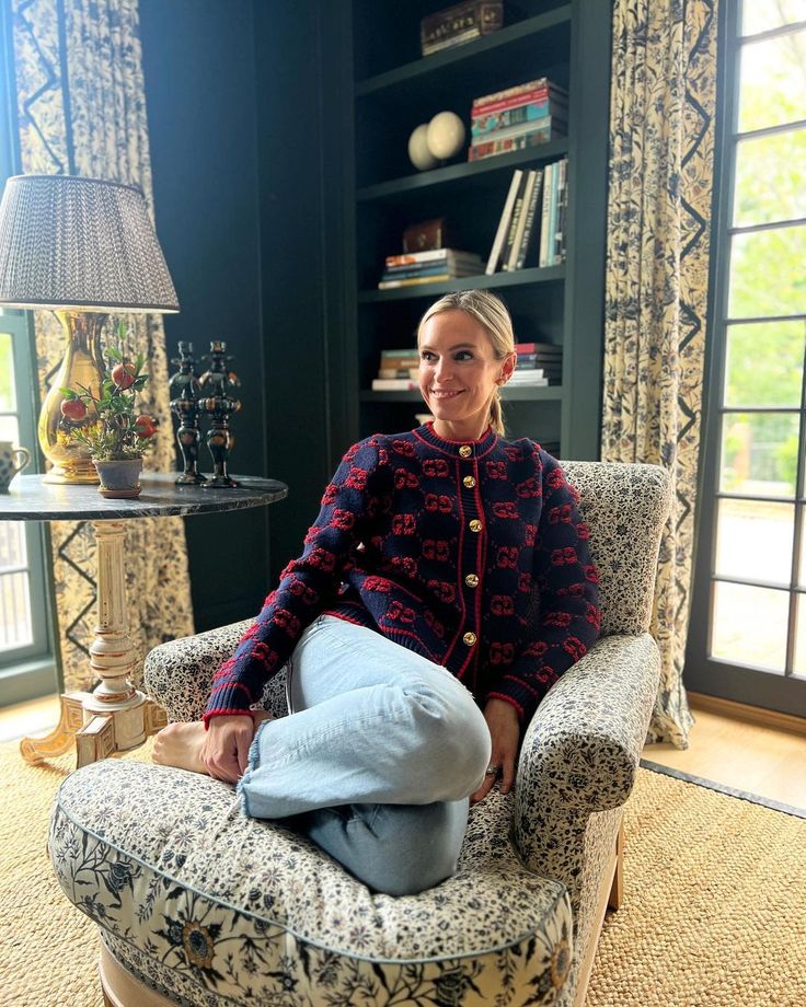 a woman sitting in a chair with her legs crossed