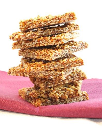 a stack of granola cookies sitting on top of a pink napkin