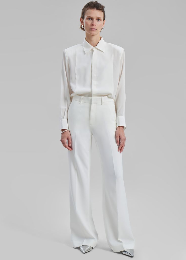 Color: Ivory Midweight woven fabric Regular fit Slightly flared leg Side seam pockets Back welt pockets Belt loops Zip fly Hook and bar closure Unlined 95% Polyester 5% Elastane Hand Wash in Cold Water By The Frankie Shop Classic Trousers, The Frankie Shop, Frankie Shop, Mini Short, Midi Skirts, Pocket Belt, Flared Pants, Office Fashion, Color Ivory