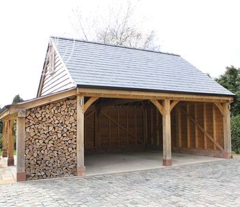 a garage with logs stacked in the front and side by side on top of it