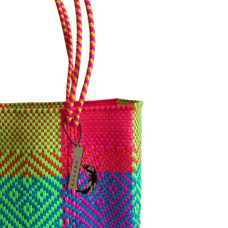 a multicolored bag with a handle on the front and side, sitting against a white background