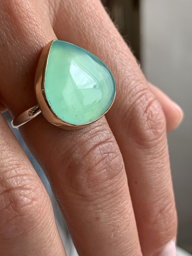 Like the depths of the most tranquil Caribbean waters this large teal Peruvian Opal is set in 14k yellow gold on our Sterling Silver Nestle band. Approximate stone size: 22mm x 20mm Approximate CT weight: 18ct Mohs hardness: 5-6.5 This mixed metal ring is lovingly handmade in our Hudson Valley studio and is one of a kind. Currently a size 8 it can be resized prior to shipping at no charge. Marquis Ring, Hexagon Necklace, Baguette Necklace, Chalcedony Necklace, Mixed Metal Rings, Bubble Necklaces, Imperial Topaz, Ruby Crystal, Peruvian Opal