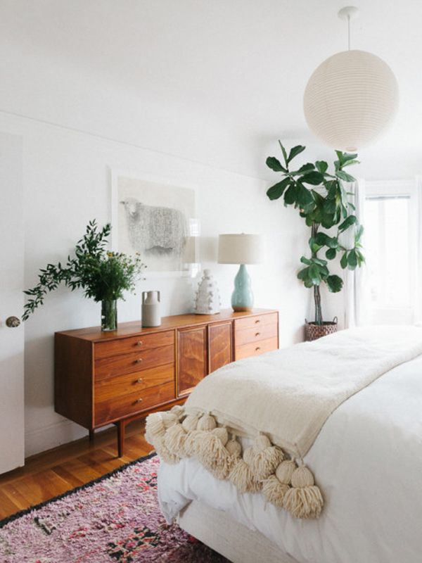 the instagram page is displayed with an image of a bed, dresser and potted plant